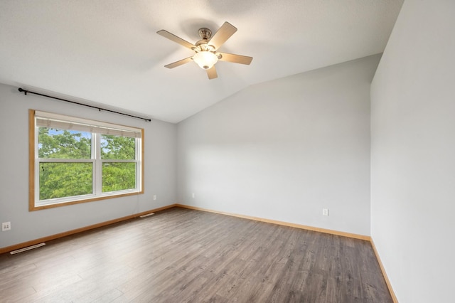 6789 Troy Ln N, Maple Grove, MN 55311 - spare room with vaulted ceiling, wood finished floors, a ceiling fan, and baseboards
