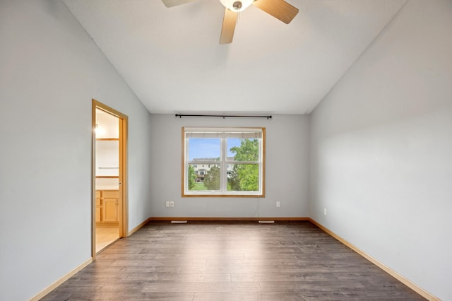 6789 Troy Ln N, Maple Grove, MN 55311 - empty room with lofted ceiling, wood finished floors, a ceiling fan, and baseboards