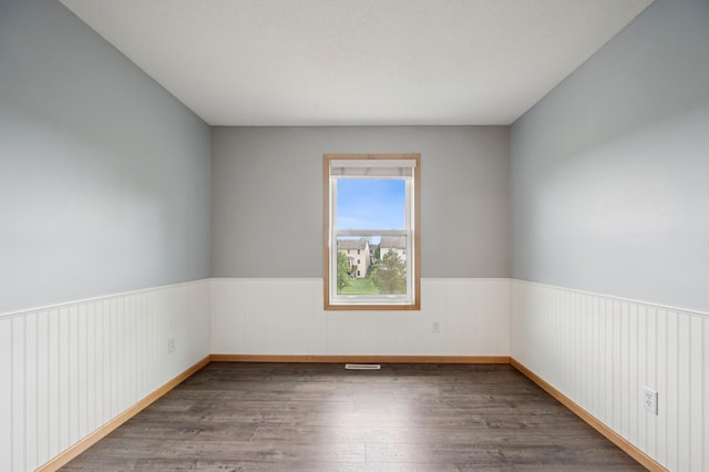 6789 Troy Ln N, Maple Grove, MN 55311 - spare room featuring wood finished floors and wainscoting
