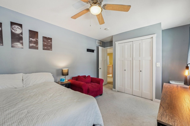 bedroom featuring a closet, light colored carpet, and ceiling fan