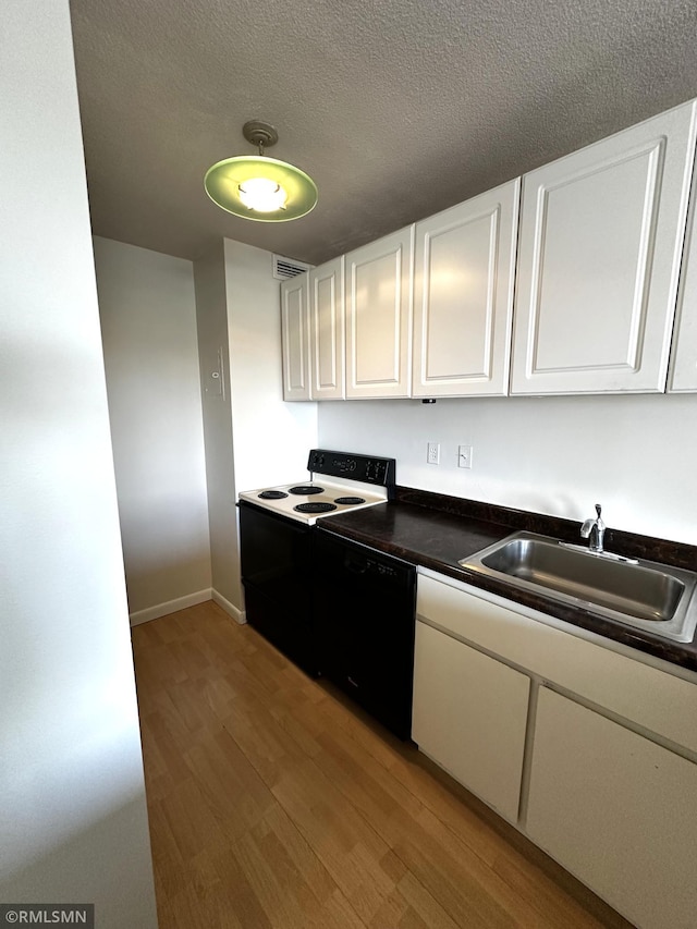 kitchen featuring white cabinets, a sink, electric range, light wood-type flooring, and dishwasher