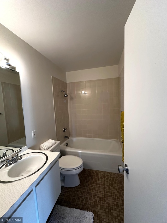 bathroom featuring tile patterned floors, toilet, bathing tub / shower combination, and vanity