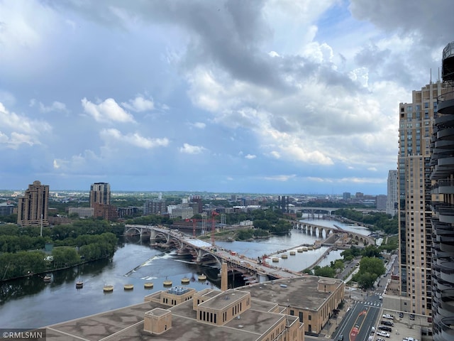 birds eye view of property with a view of city and a water view