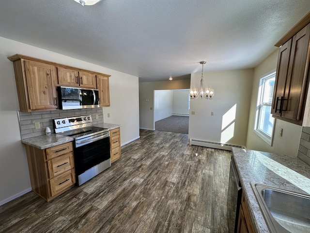 kitchen featuring stainless steel appliances, backsplash, a baseboard heating unit, dark wood-type flooring, and a sink