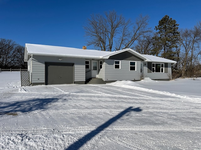 view of front of house with an attached garage and a chimney