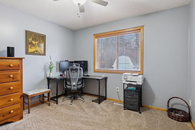 office space featuring carpet floors, ceiling fan, and baseboards