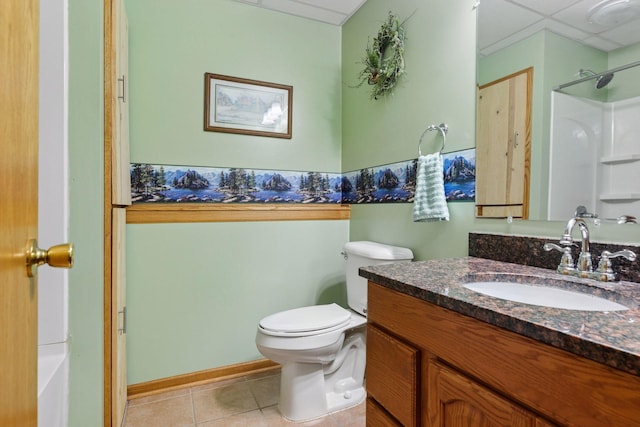 full bath with a drop ceiling, tile patterned flooring, toilet, vanity, and a shower