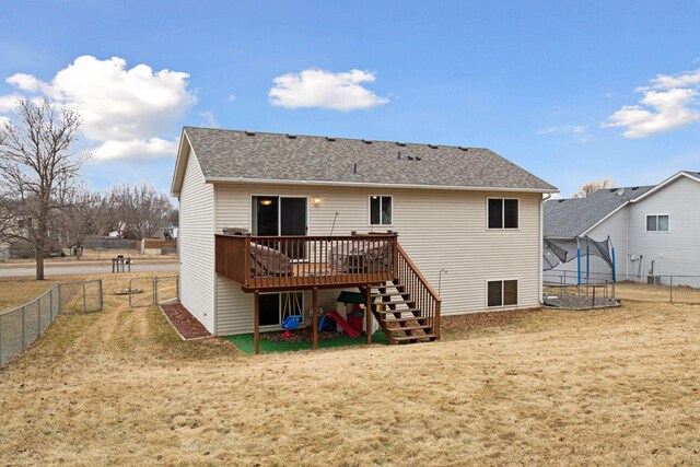 back of house with fence private yard, a lawn, and stairway