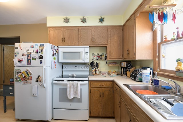 kitchen featuring sink and white appliances