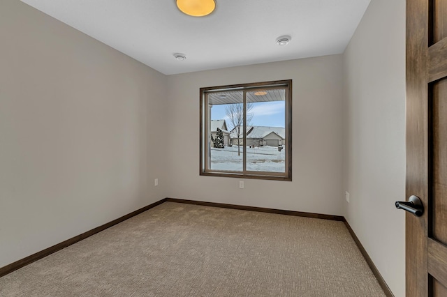 unfurnished room featuring light colored carpet