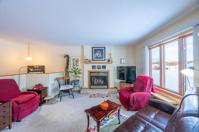 living room featuring a tiled fireplace, carpet, and a textured ceiling