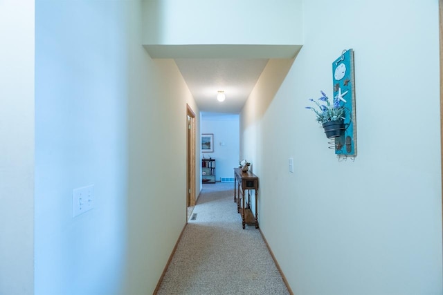 hall with light colored carpet