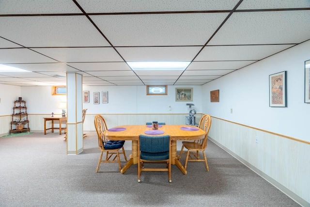 dining space with carpet flooring and a drop ceiling