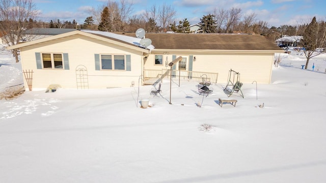 view of snow covered back of property