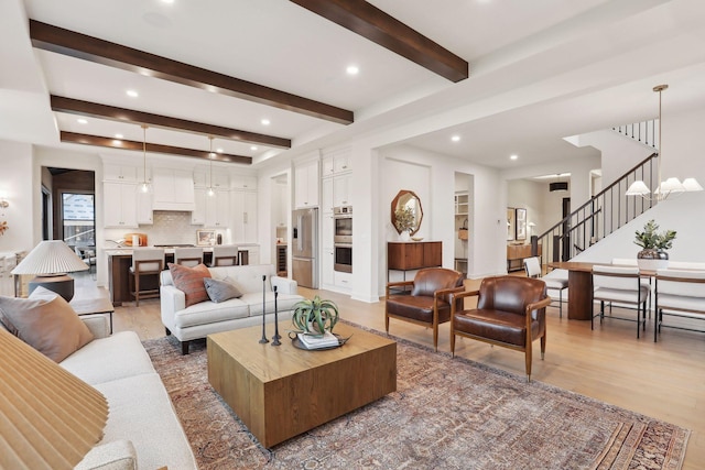 living room with beamed ceiling and wood-type flooring