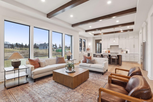 living room with beam ceiling and light hardwood / wood-style floors