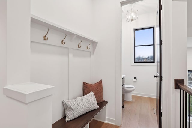 mudroom featuring hardwood / wood-style floors and a chandelier