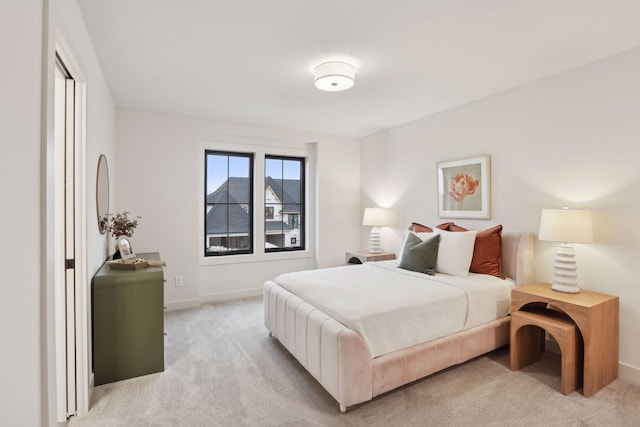 bedroom featuring light colored carpet