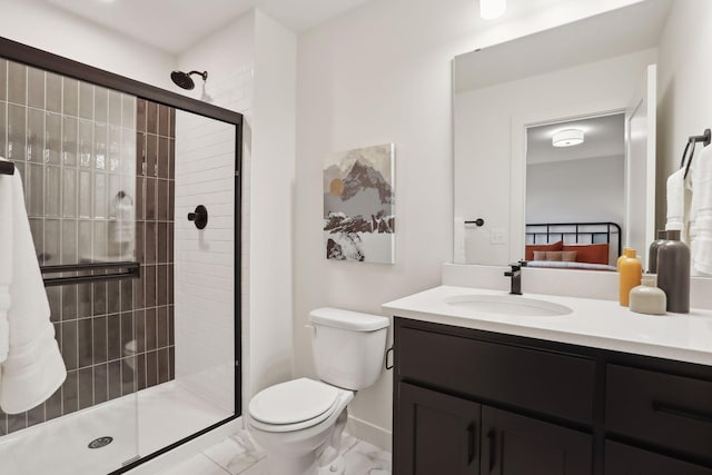 bathroom with vanity, a shower with shower door, and toilet