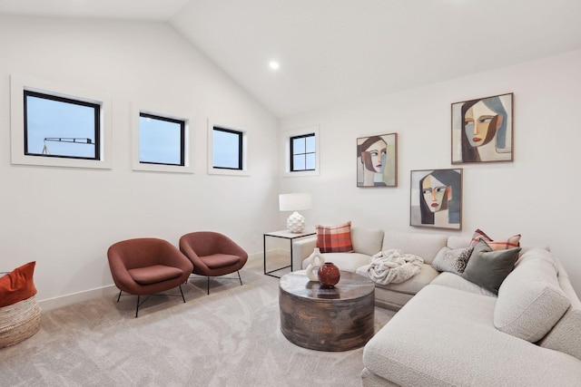 living room with high vaulted ceiling and light carpet