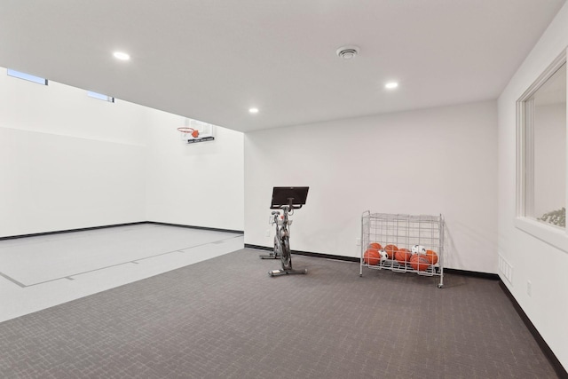 exercise area featuring dark colored carpet