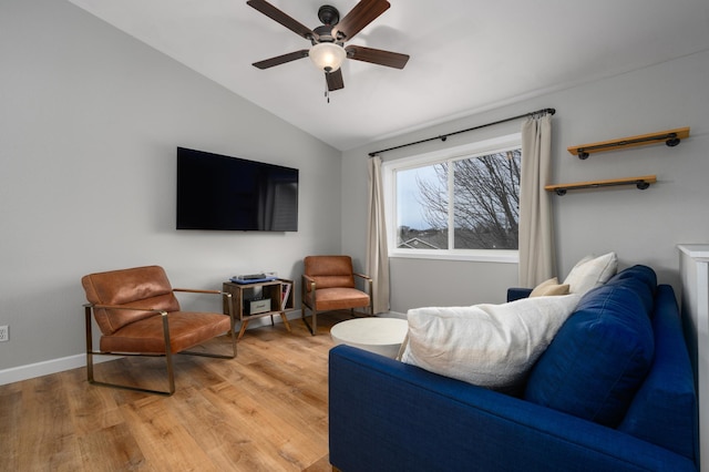 living area featuring vaulted ceiling, a ceiling fan, light wood-type flooring, and baseboards