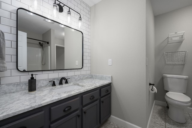 full bath featuring vanity, baseboards, tile patterned flooring, walk in shower, and toilet