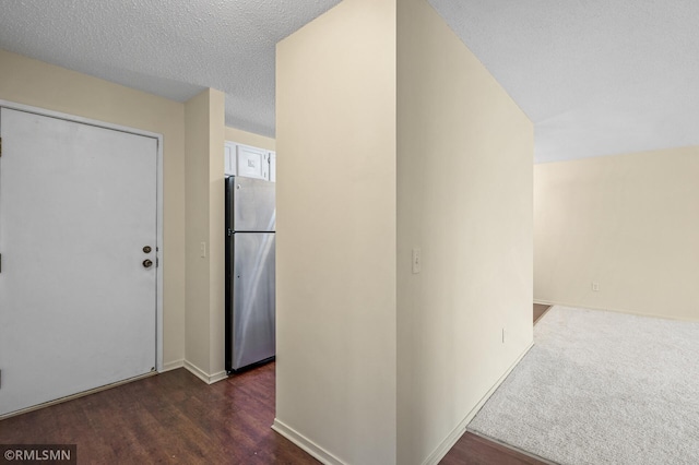 corridor featuring dark hardwood / wood-style flooring and a textured ceiling