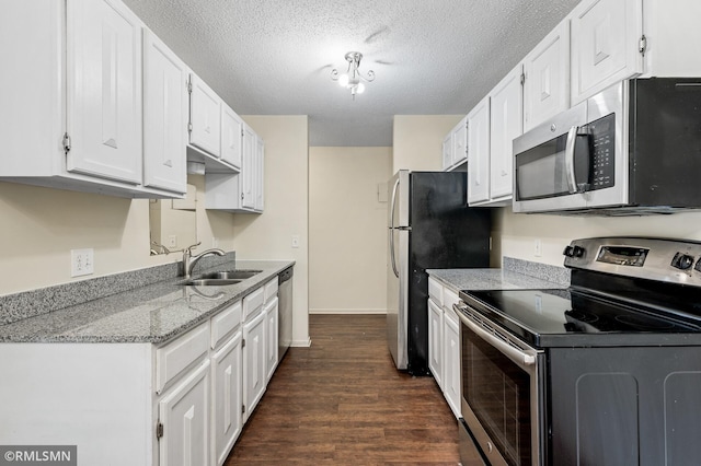 kitchen with sink, white cabinets, stainless steel appliances, dark wood-type flooring, and a textured ceiling