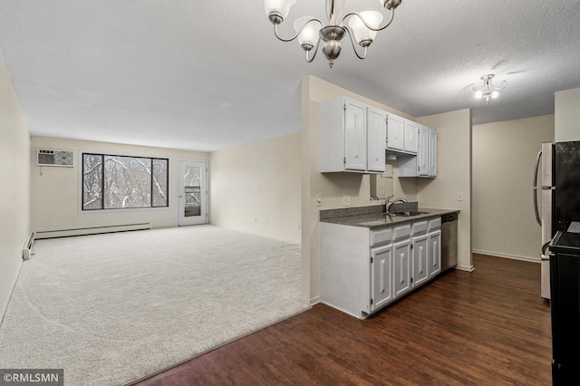 kitchen featuring sink, a chandelier, a baseboard radiator, dishwasher, and dark carpet