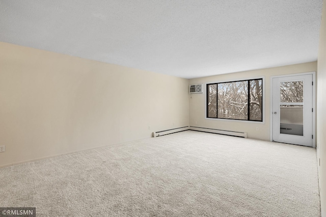 empty room with baseboard heating, light colored carpet, a textured ceiling, and an AC wall unit