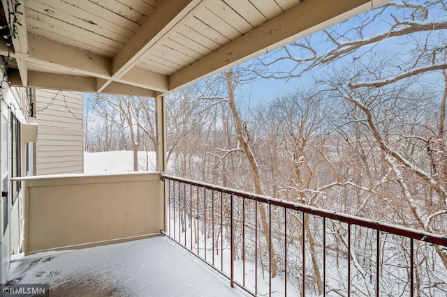 view of snow covered back of property