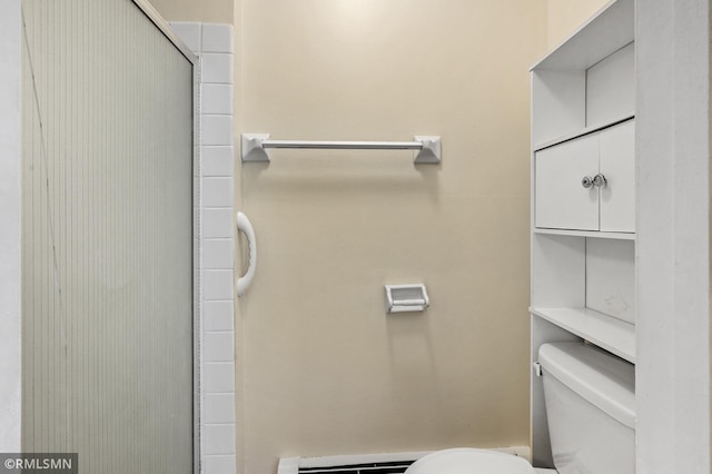 bathroom with walk in shower, toilet, and a baseboard heating unit