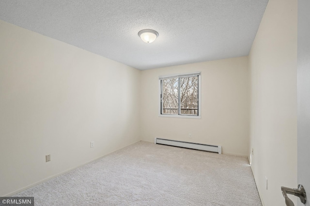 spare room featuring light carpet, a baseboard radiator, and a textured ceiling