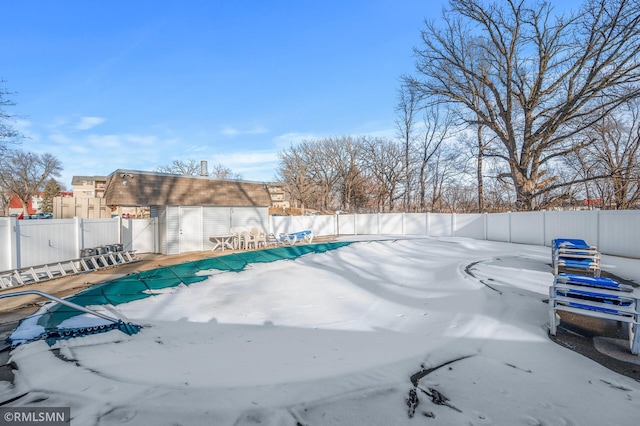 view of pool with a storage shed