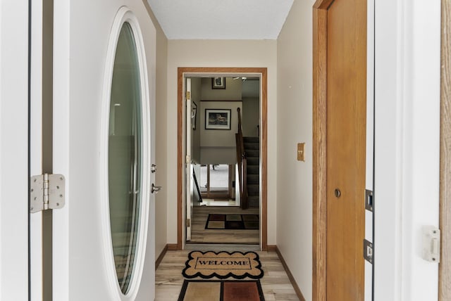 corridor with light hardwood / wood-style floors