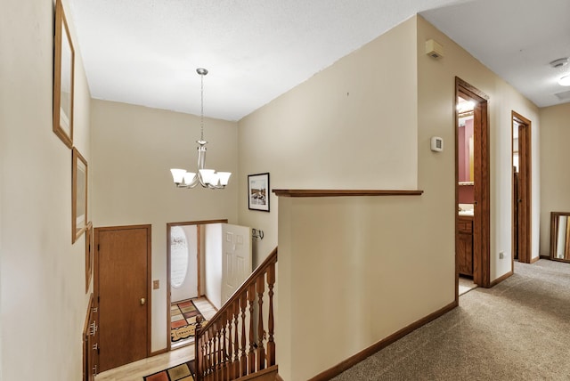 carpeted foyer with a high ceiling and a chandelier