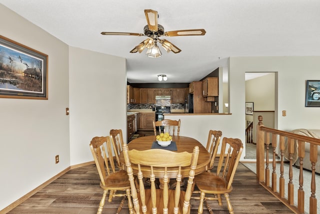 dining room with dark hardwood / wood-style floors and ceiling fan