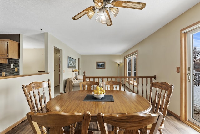 dining room featuring a textured ceiling, light hardwood / wood-style floors, and ceiling fan