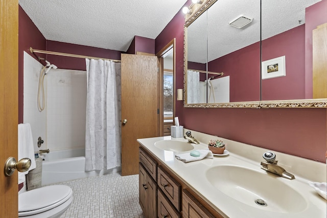 full bathroom featuring tile patterned flooring, vanity, toilet, shower / bathtub combination with curtain, and a textured ceiling