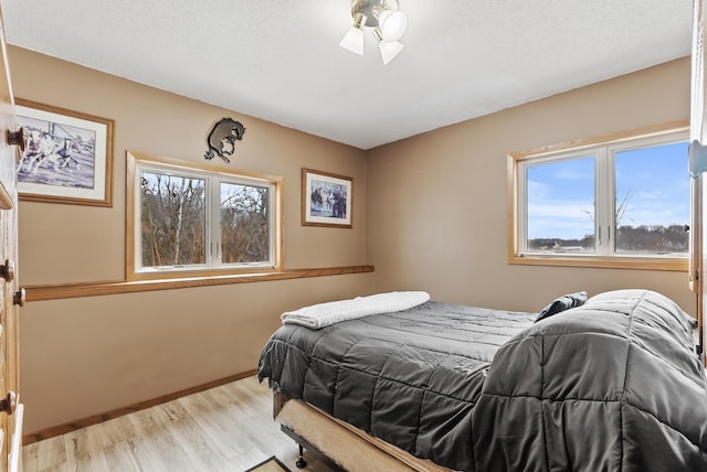 bedroom featuring light hardwood / wood-style flooring and a textured ceiling