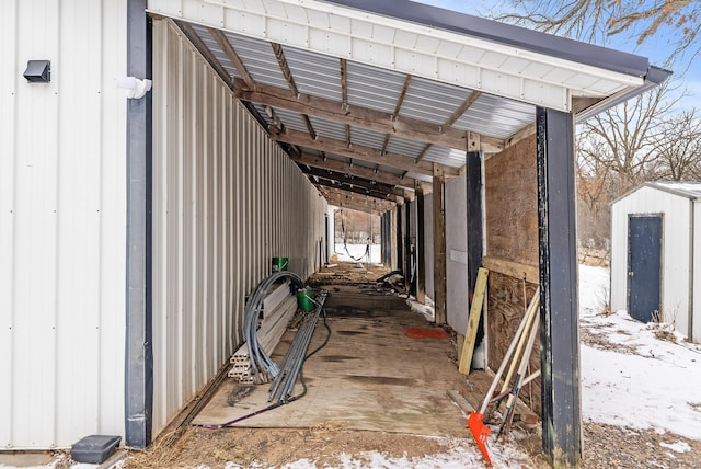 view of snow covered exterior featuring a storage unit