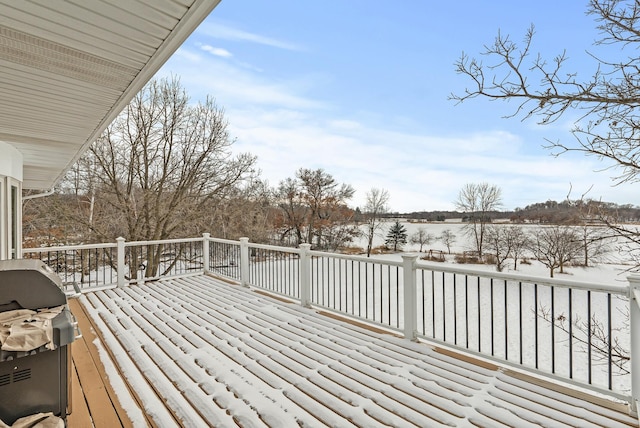 snow covered deck featuring a grill