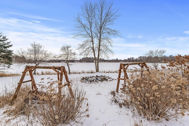 yard layered in snow with a rural view