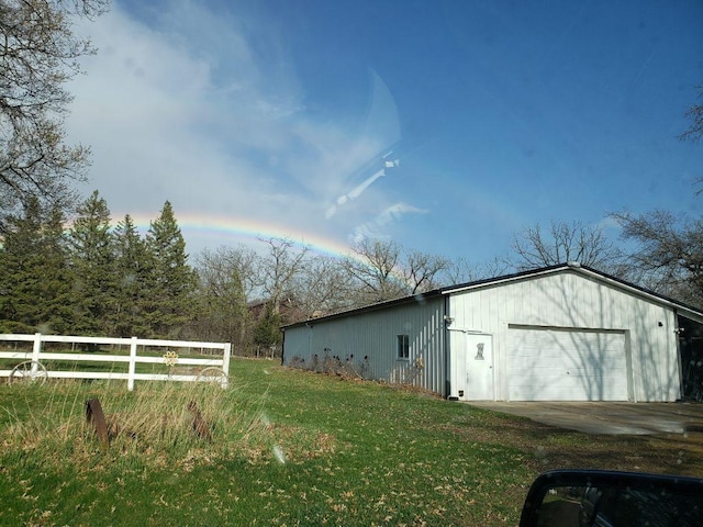 view of outbuilding with a garage and a yard