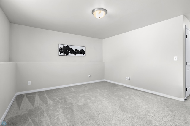 spare room featuring light colored carpet