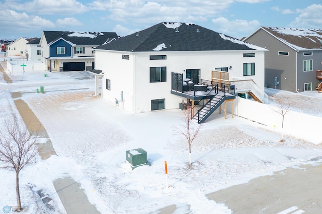 snow covered property featuring a wooden deck