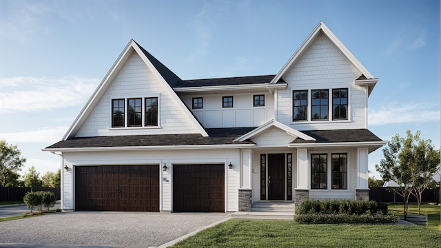 view of front of house with a front yard, driveway, an attached garage, and fence