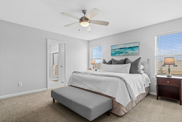 carpeted bedroom with connected bathroom and ceiling fan