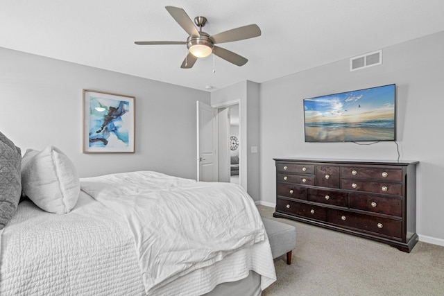 bedroom with ceiling fan and light colored carpet